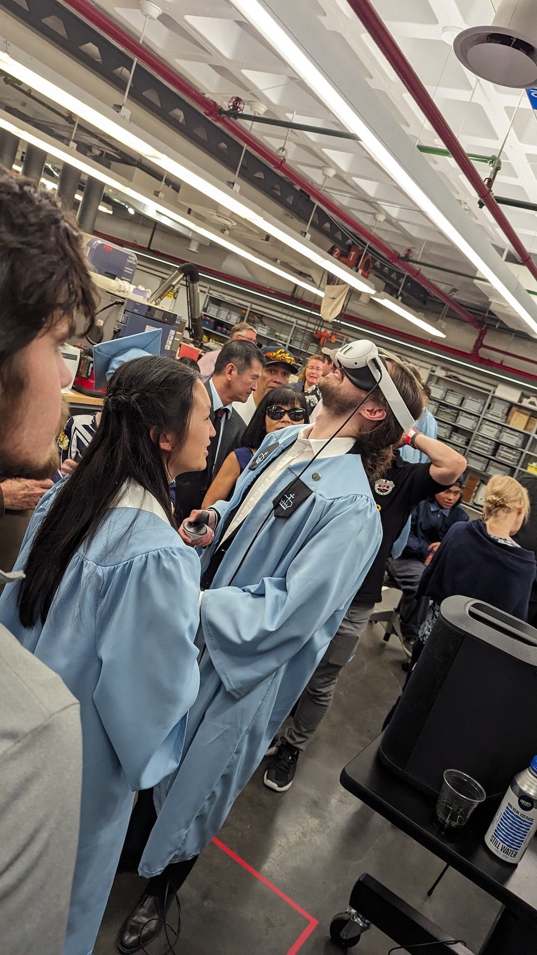 Two graduates testing a VR headset