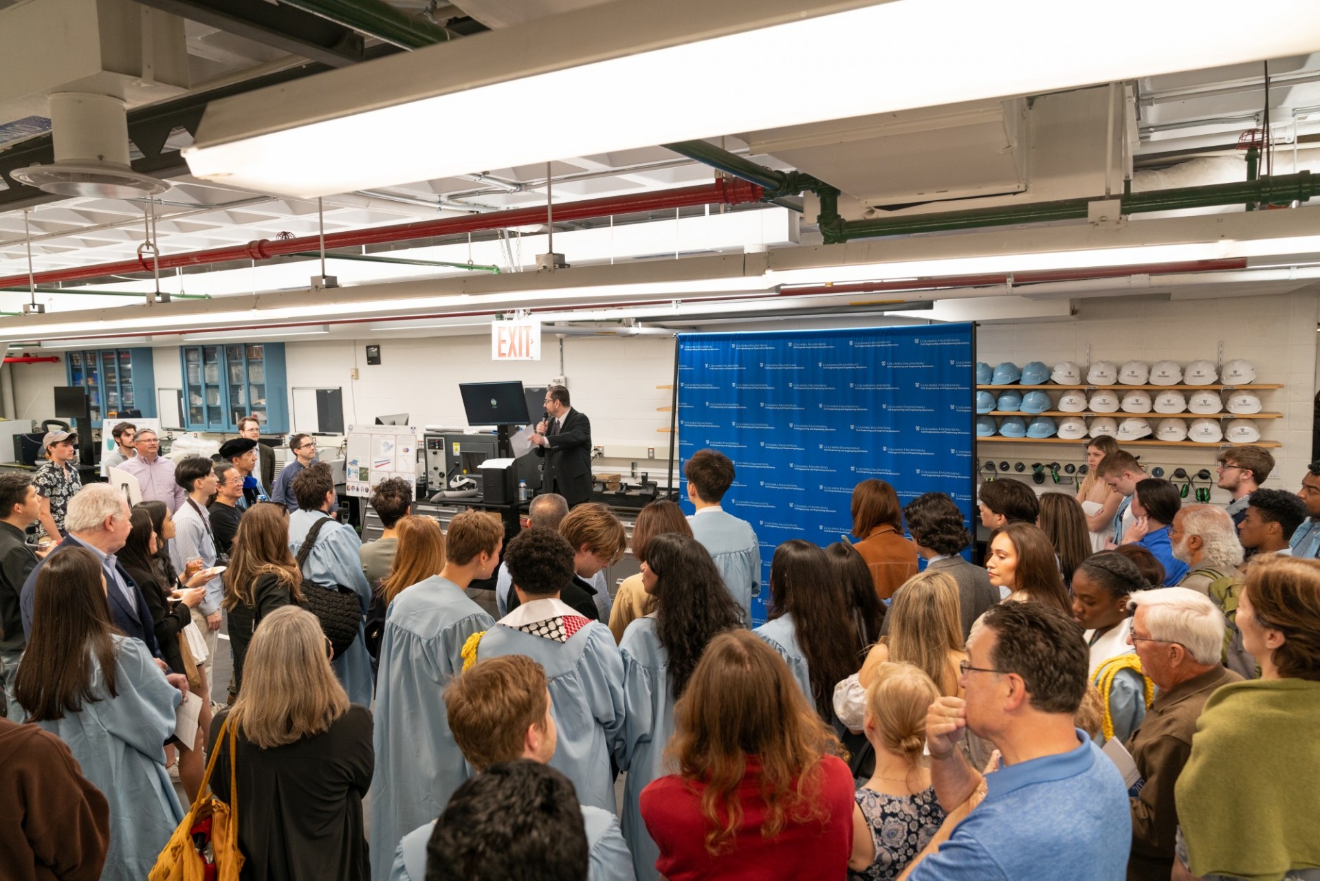 Graduates and staff gather together for the awards ceremony in the Carleton Lab.
