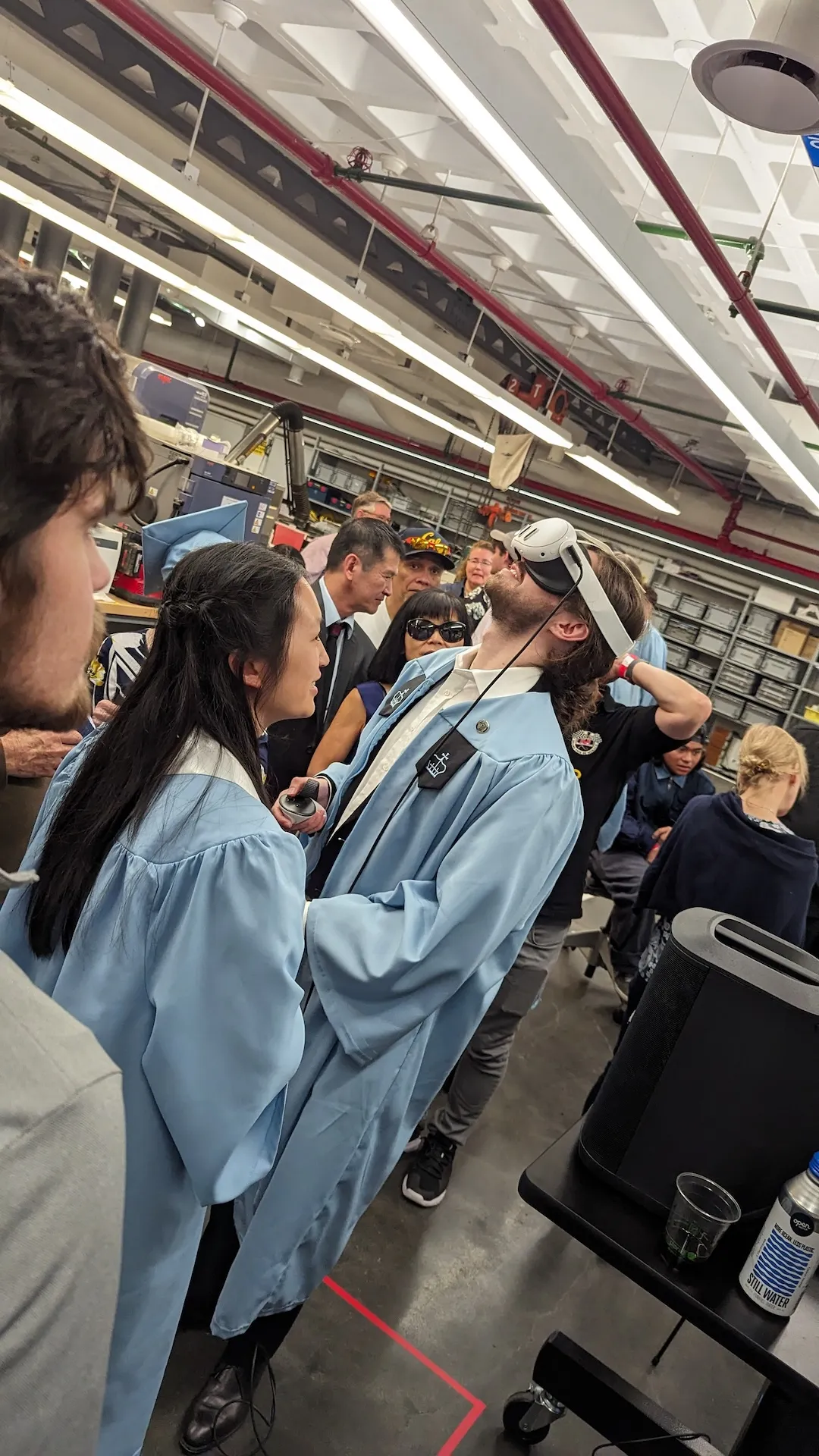 Two graduates testing a VR headset