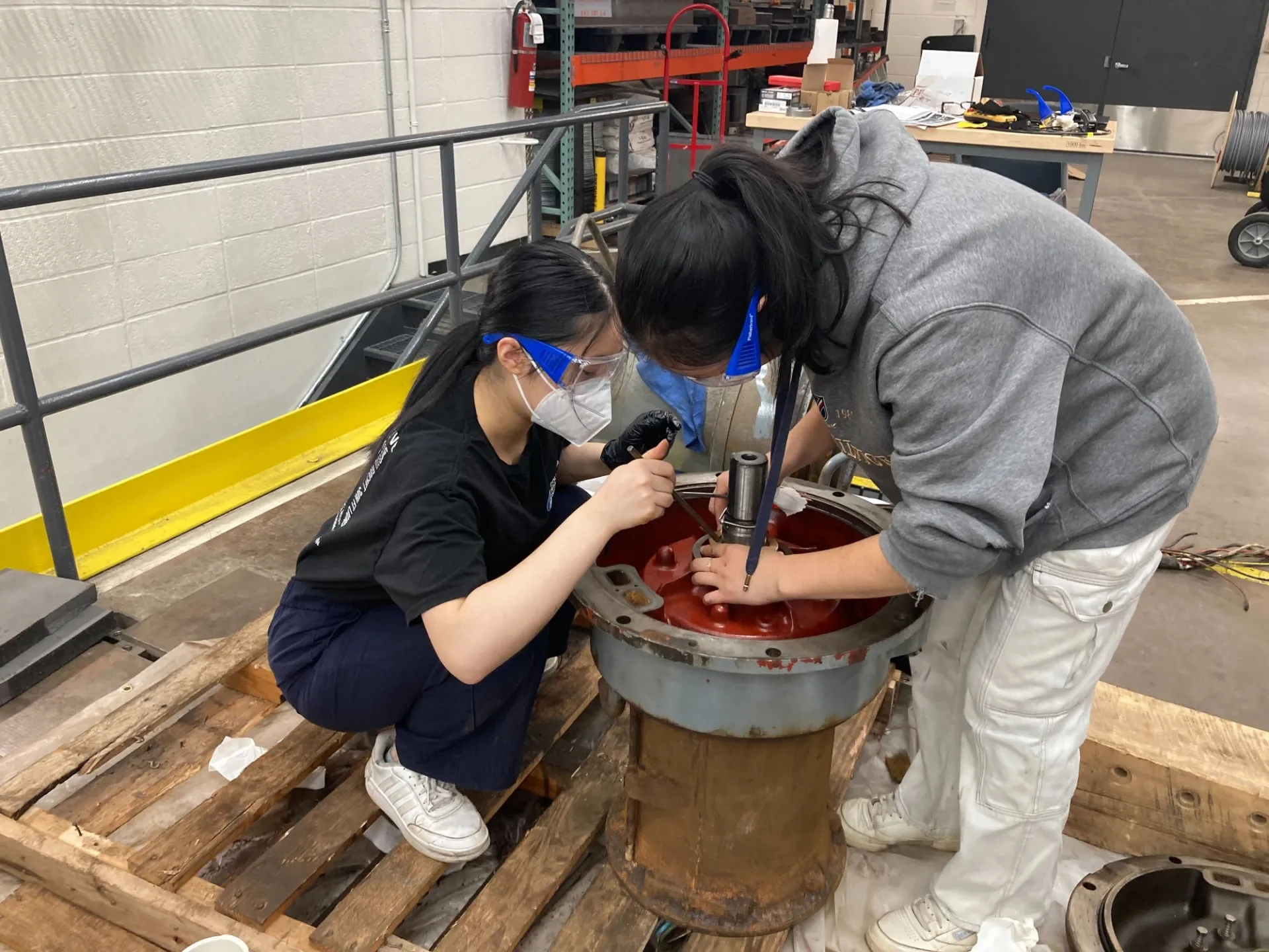 Two civil engineering students repairing the pumps