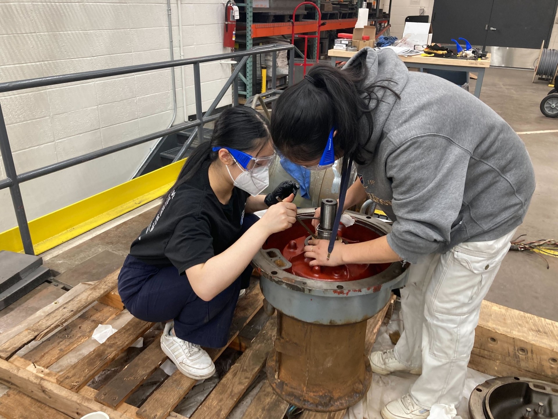 Two civil engineering students repairing the pumps